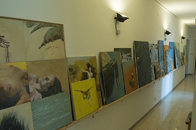 Shelf of paintings in Studio